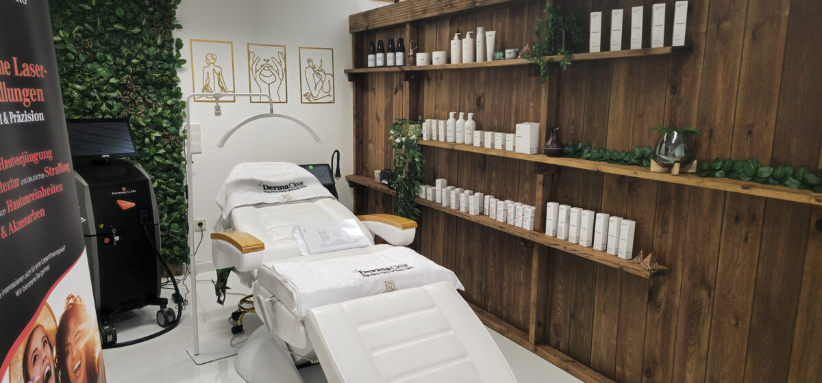 Behandlungsraum im Kosmetikstudio Le Derma Code Bielefeld mit Liege und Holzregalen voller Pflegeprodukte